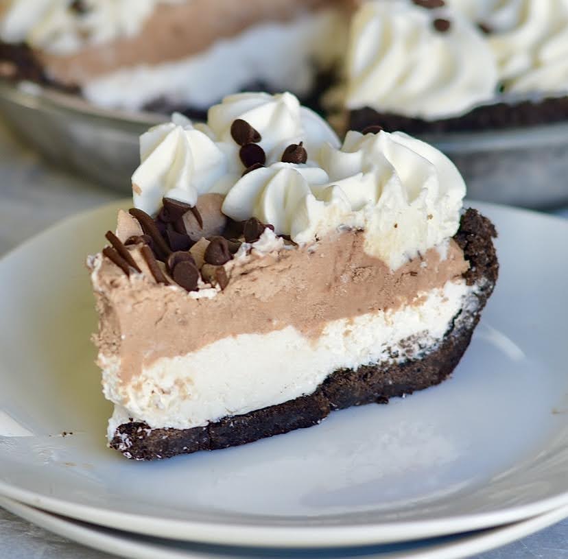 a slice of chocolate cream pie on a white plate