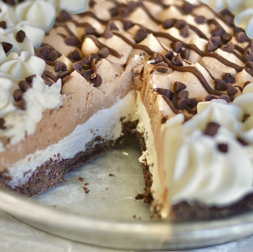 a cross section of chocolate cream pie with a slice missing