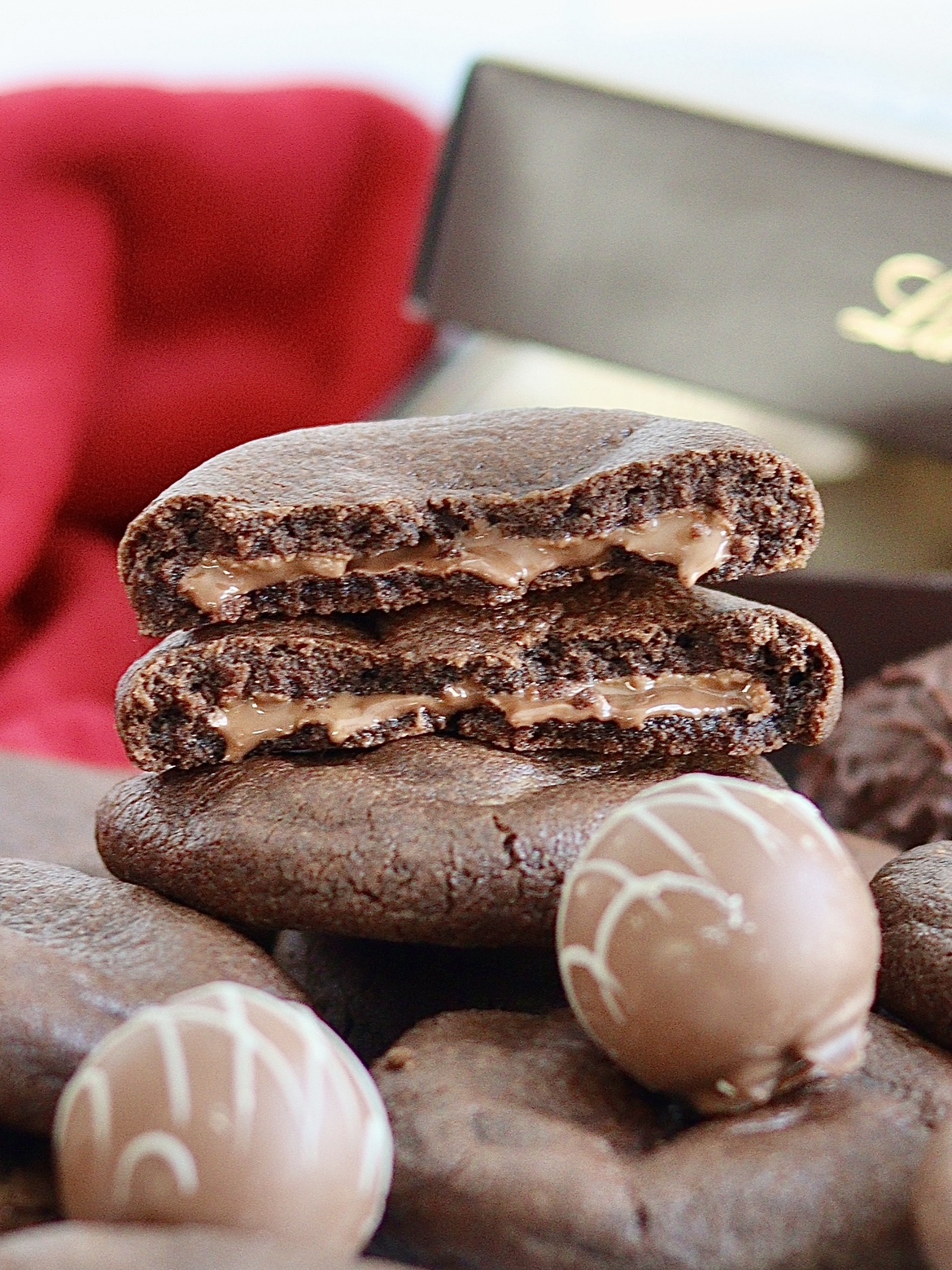 chocolate cookies broken in half to show chocolate truffle filling