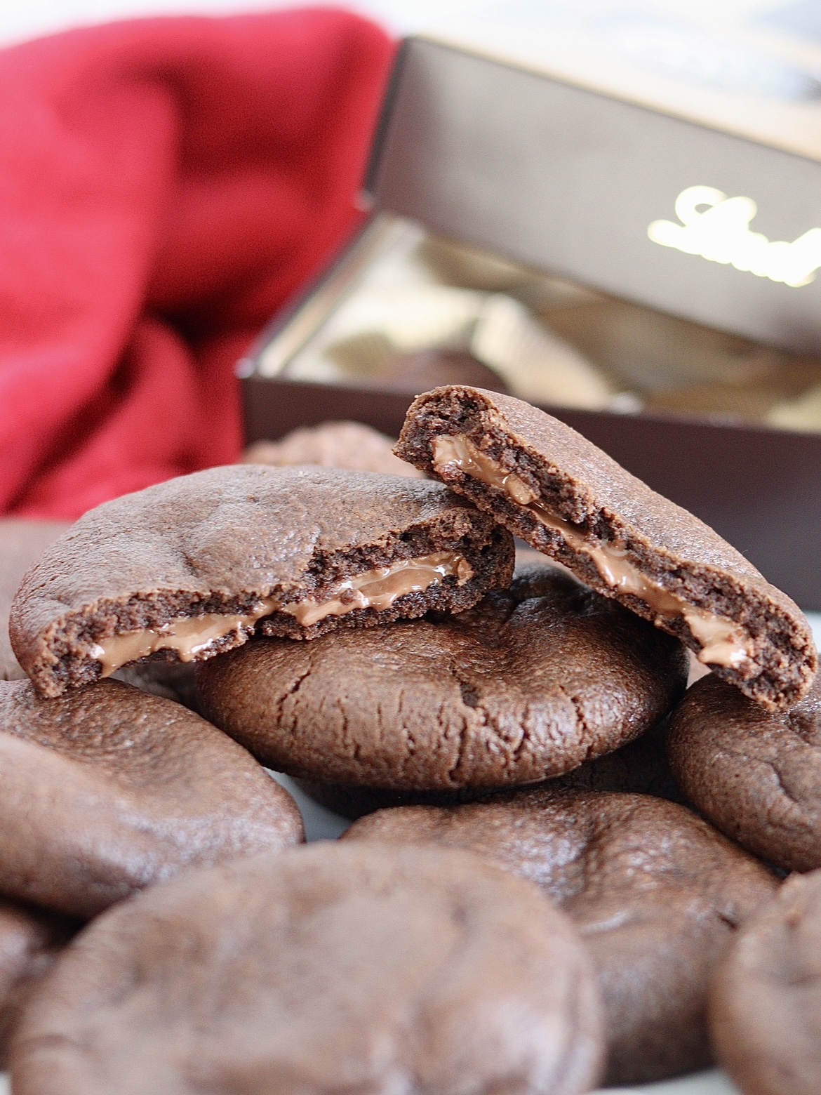 chocolate cookies broken open to show chocolate truffle filling