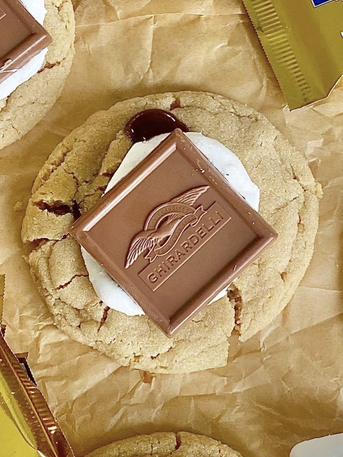 a chocolate-filled peanut butter cookie topped with a marshmallow and Ghirardelli chocolate square