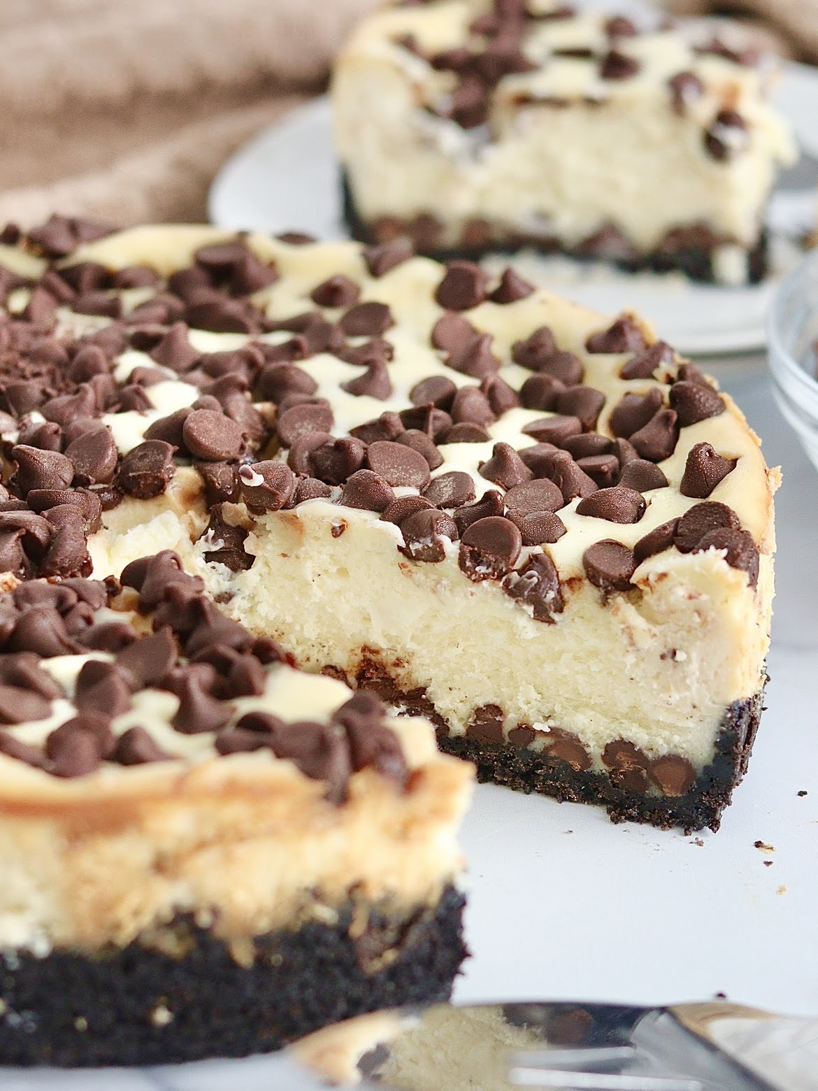 Chocolate Chip Cheesecake with a slice taken out of it.