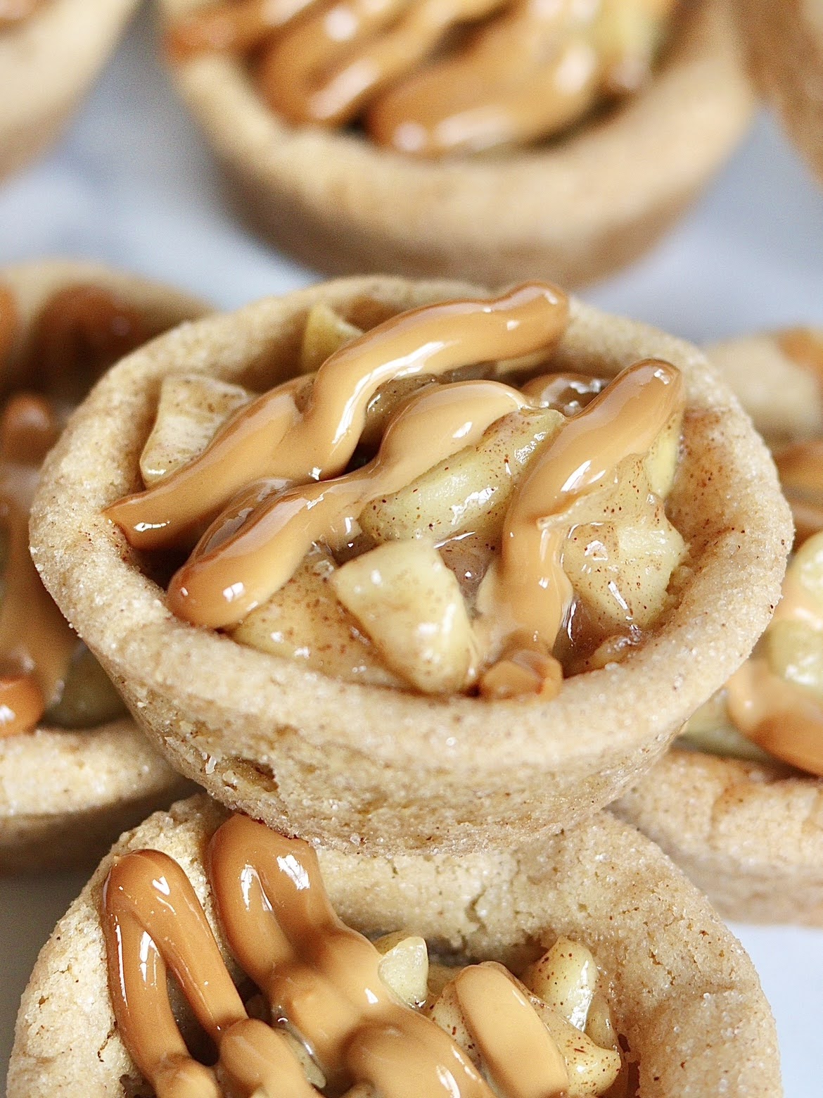 A close up photo of a fully assembled caramel apple pie cookie cup