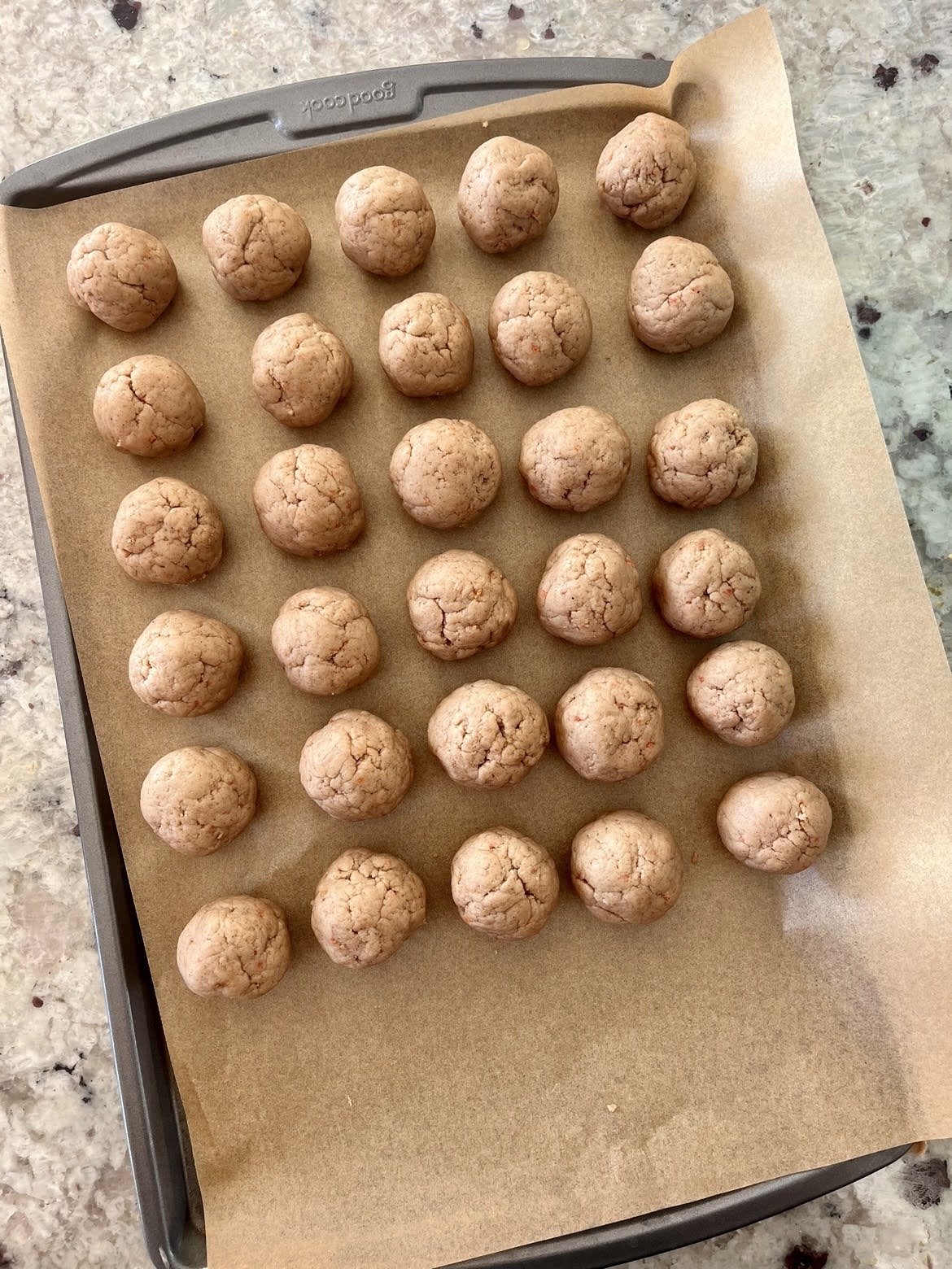 A process photo of the rolled truffles, prior to being coated with white chocolate.