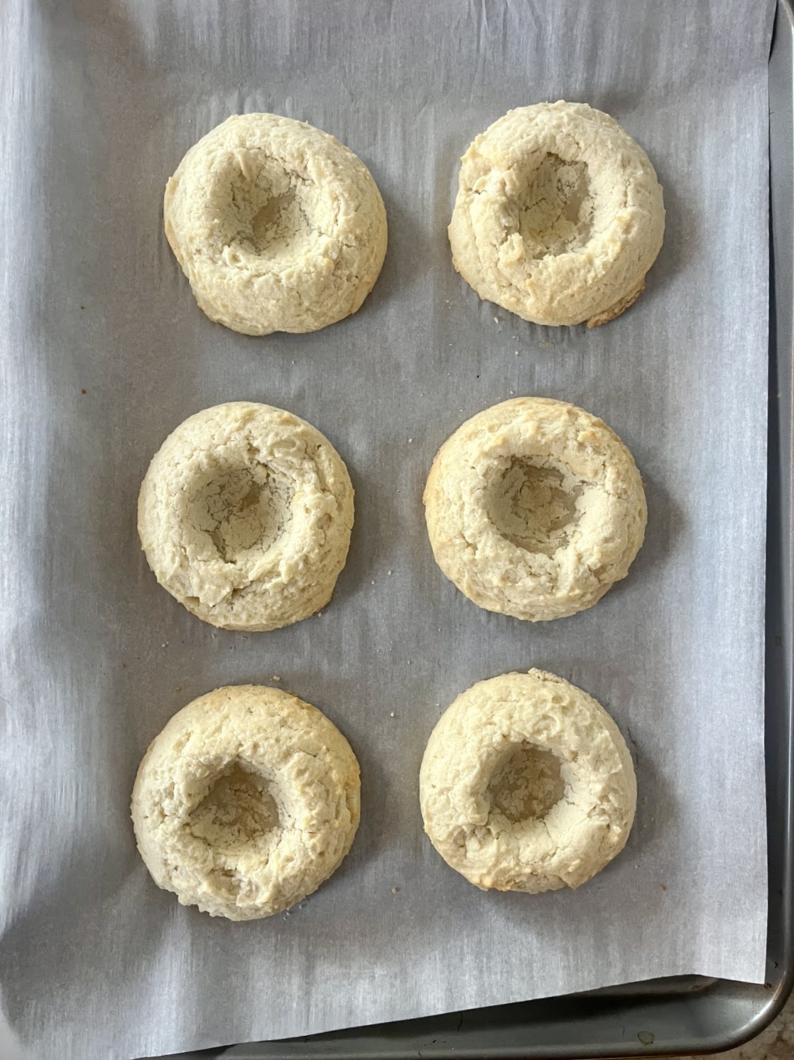 A process photo of baked cookies with an indent added.