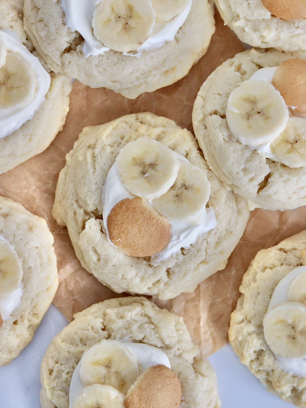 An overhead photo of multiple banana cream pie cookies topped with sliced bananas and Nilla Wafers.